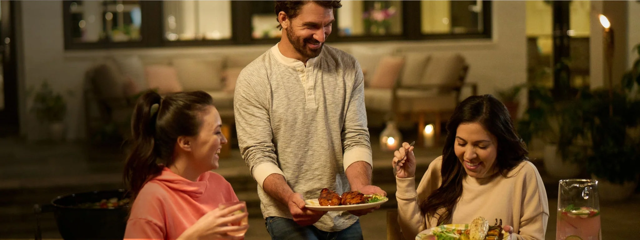 Image of man placing food on a table.